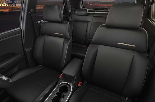black leather^ seat upholstery with brass coloured highlights