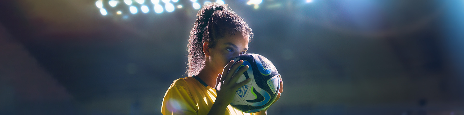 <Placeholder copy> Image of woman footballer dressed in football attire from the 1890s to the present day—wearing a Goal of the Century jersey.