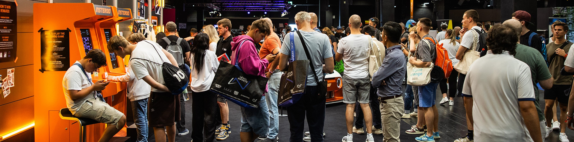Visitors at the Cologne gamescom engage with the Hyundai gaming machines and the displayed Hyundai INSTEROID
