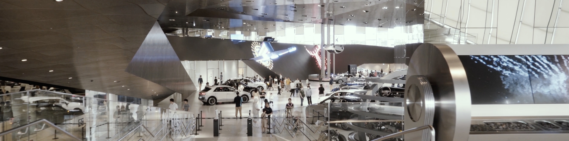 A large exhibition hall showcasing Hyundai vehicles