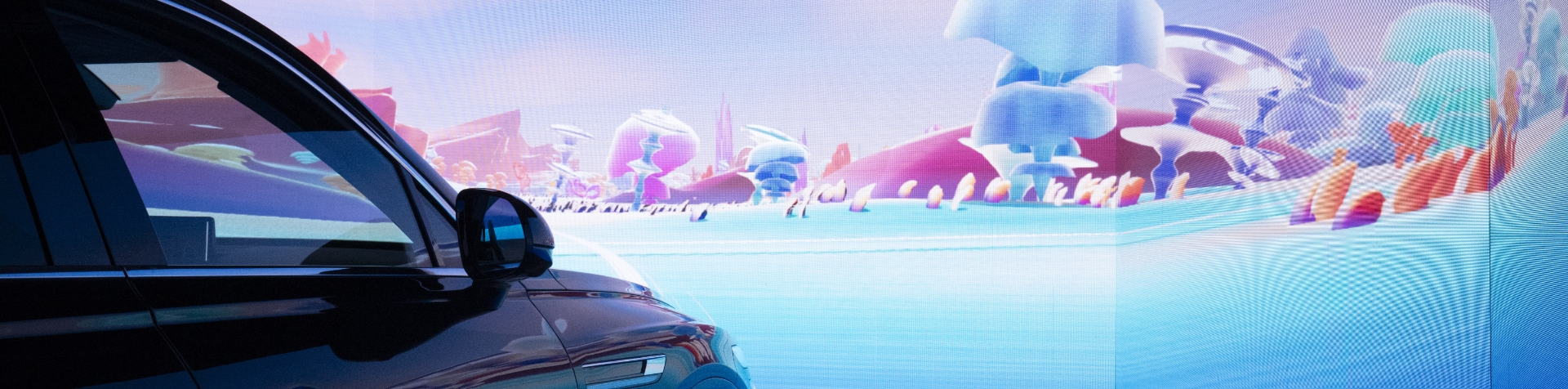 The Timescaper installation shows a parked GENESIS GV80 in front of an animated screen displaying a colorful landscape.