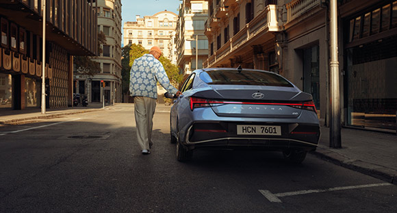 A man is next to the new ELANTRA, which is sophisticated.