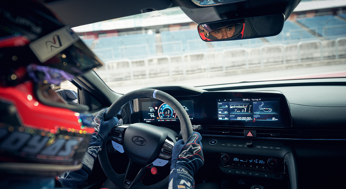 Race-inspired Alcantara steering wheel with a Performance Blue top marker