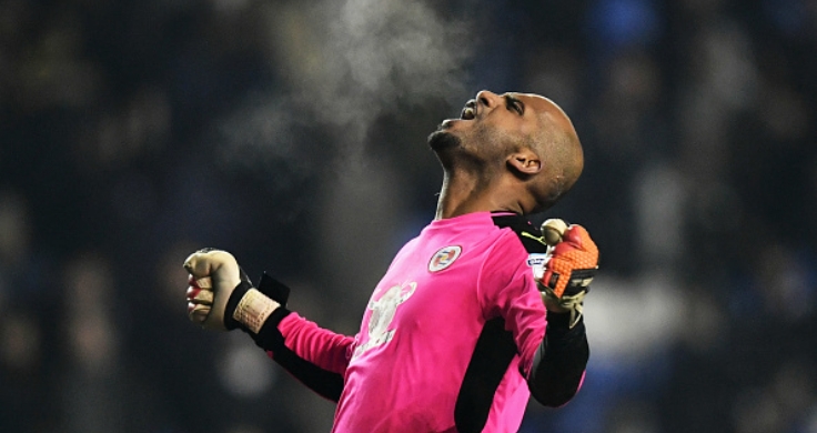 Side torso view of Team Century male footballer Ali Al-Habsi in a magenta jersey leaning back with his arms out to his side and fists clenched giving a victorious shout to the skies.